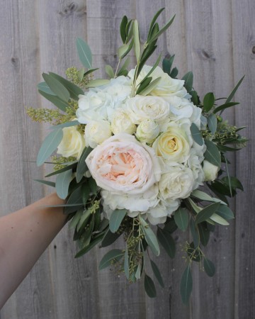 bridesmaid bouquet - ivory and blush flowers - white o'hara rose - ivory garden spray rose - ivory avalanche rose - berried eucalyptus - olive foliage 