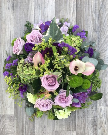 lilac and purple posy display - funeral tribute design - lilac rose - purple lisianthus - calla lily 