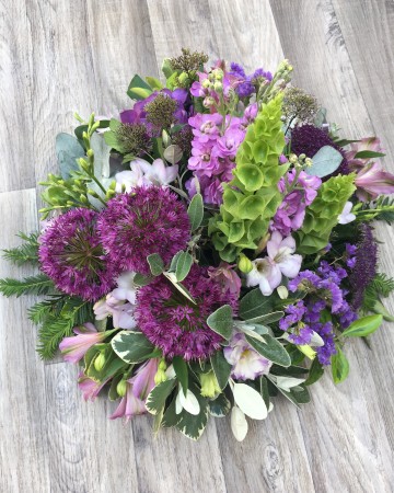 lilac and purple posy display - funeral tribute design - lilac rose - purple lisianthus - allium - freesia