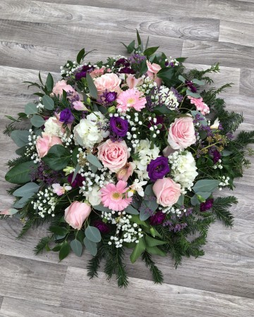 pink and purple posy display - fuberal tribute posy design - pink roses germini freesia - purple lisianthus - limonium - ivory hydrangea gypsophilia