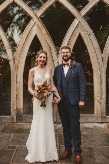 Autumnal wedding at shustoke farm barns - Orange gold navy and nude wedding flowers - quicksand roses - orange roses - blue vibernum - crocosmia - gold fern - floral arch - table plan flowers - wedding cake flowers 