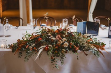 Autumnal wedding at shustoke farm barns - Orange gold navy and nude wedding flowers - quicksand roses - orange roses - blue vibernum - crocosmia - gold fern - floral arch - table plan flowers - wedding cake flowers 
