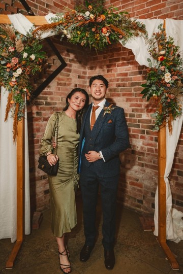 Autumnal wedding at shustoke farm barns - Orange gold navy and nude wedding flowers - quicksand roses - orange roses - blue vibernum - crocosmia - gold fern - floral arch - table plan flowers - wedding cake flowers 