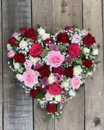full heart of mixed pink red and ivory roses 