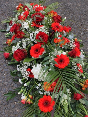 Casket Spray Featuring Red Rose, Germini, Freesia, Ivory Hydrangea, Spray Carnation and Gypsophila