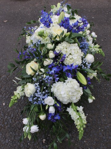 casket spray in royal blue and white colours - BCFC colour funeral tribute
