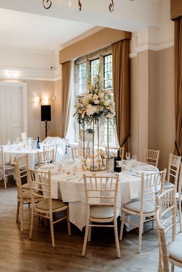Table Centrepiece on gold stand - ivory and white floral displays featuring Hydrangea, Avalanche Rose, Anthuriums, Peony and Gypsophila - at Moxhull Hall wedding Venue 