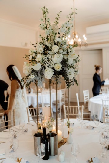 Table Centrepiece on gold stand - ivory and white floral displays featuring Hydrangea, Avalanche Rose, Anthuriums, Peony and Gypsophila - at Moxhull Hall wedding Venue