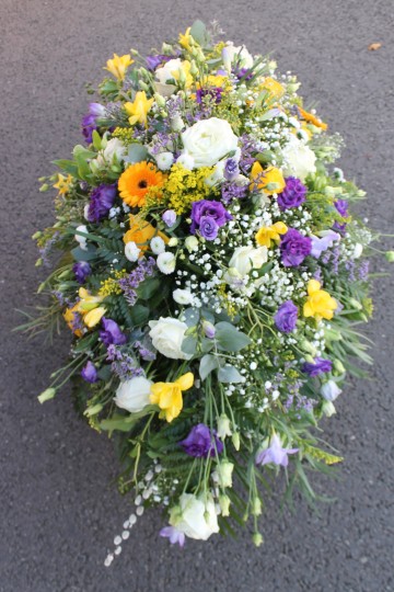 casket spray lemon purple and ivory flowers