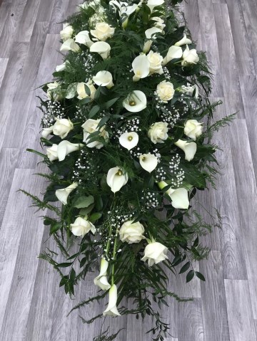 white Rose and Calla Lilly casket spray with soft trailing fern 