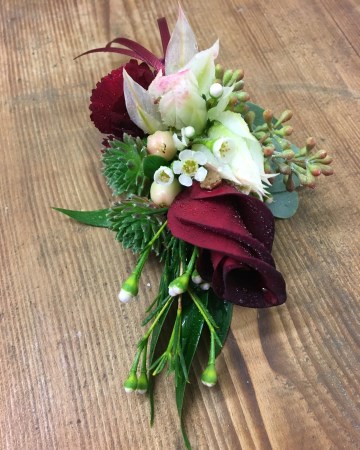grooms autumnal buttonhole - rolled deep red rose petals - with ivory and blush blooms to match bridal bouquet