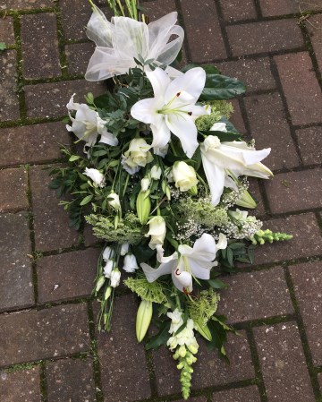 white hand tied sheaf funeral tribute design - white oriental lily - Antirrhinum - roses - lisianthus - ammi - gypsophilia 