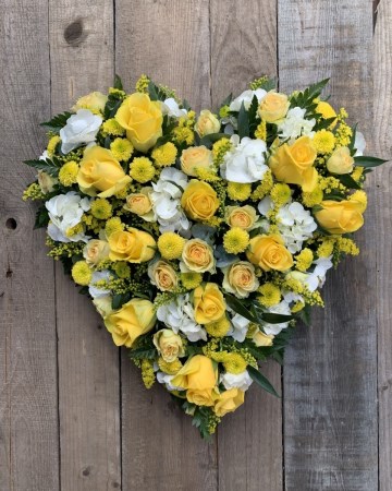 full heart featuring yellow roses and ivory lisianthus with mix yellow flowers