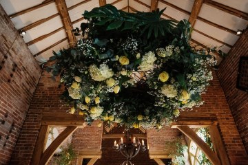 hanging floral wreath suspended from ceiling of shustoke farm barns - yellow and lemon flowers 
