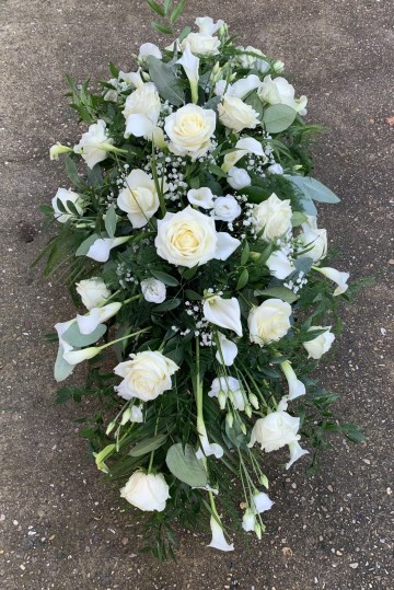 calla lily, Rose and Lisanthus casket spray in whites and ivory 