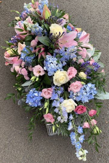 blush, pale blue and ivory casket spray - lisianthus - roses - delphiniums- hydrangea 